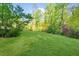 Expansive, beautifully manicured backyard surrounded by lush green trees at 45 Michelle Ne Cir, Atlanta, GA 30342