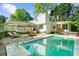Inviting backyard with a sparkling pool, outdoor lounge area, and beautifully landscaped surroundings at 45 Michelle Ne Cir, Atlanta, GA 30342