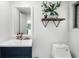 Bright bathroom featuring a modern vanity, sleek fixtures, and a stylish accent shelf with botanical decor at 45 Michelle Ne Cir, Atlanta, GA 30342