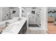 Bathroom featuring dual sinks, modern finishes, and a spacious walk-in shower with white subway tile at 45 Michelle Ne Cir, Atlanta, GA 30342