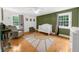 Bright bedroom featuring an accent wall and hardwood floors at 45 Michelle Ne Cir, Atlanta, GA 30342