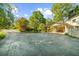Long driveway leading to a charming home with an inviting covered porch and American flags at 45 Michelle Ne Cir, Atlanta, GA 30342