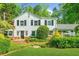 Charming home featuring a brick foundation, manicured landscaping, and elegant shuttered windows at 45 Michelle Ne Cir, Atlanta, GA 30342