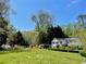 Traditional home with a sprawling green lawn and mature trees creating a picturesque and private setting at 45 Michelle Ne Cir, Atlanta, GA 30342