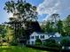 Traditional home on a well-manicured lawn with mature trees under a beautiful sky with fluffy clouds at 45 Michelle Ne Cir, Atlanta, GA 30342