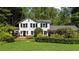 Charming two-story home with black shutters, lush landscaping, and a brick entryway, offering classic curb appeal at 45 Michelle Ne Cir, Atlanta, GA 30342