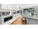 Modern kitchen with white subway tile backsplash, stainless steel appliances, hardwood floors, and granite countertops at 45 Michelle Ne Cir, Atlanta, GA 30342