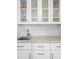 Close up of wet bar area with white cabinets and bronze hardware at 45 Michelle Ne Cir, Atlanta, GA 30342