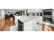 Spacious kitchen with island, stainless steel appliances, white cabinets, and an open layout to the living room at 45 Michelle Ne Cir, Atlanta, GA 30342