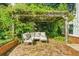 Cozy brick patio featuring comfortable seating under a charming pergola covered in climbing plants at 45 Michelle Ne Cir, Atlanta, GA 30342