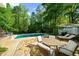 Relaxing backyard with a refreshing pool, dining area, and comfortable lounge chairs at 45 Michelle Ne Cir, Atlanta, GA 30342