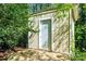 Outdoor shed surrounded by lush foliage, provides ample storage and blends with the nature at 45 Michelle Ne Cir, Atlanta, GA 30342