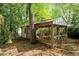 Outdoor shed with a screened area, nestled among trees, perfect for relaxation and nature enjoyment at 45 Michelle Ne Cir, Atlanta, GA 30342