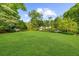 Lush green front yard with mature trees surrounding a beautiful home at 45 Michelle Ne Cir, Atlanta, GA 30342