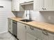 Updated kitchen with light gray cabinets, butcher block counters, stainless steel sink, and modern fixtures at 475 Mount Vernon Ne Hwy # 129C, Atlanta, GA 30328