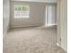 A spacious living room with neutral carpet and a large window for ample natural light at 475 Mount Vernon Ne Hwy # 129C, Atlanta, GA 30328