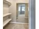 A large walk-in closet with carpeted floors and plenty of shelving for storage at 475 Mount Vernon Ne Hwy # 129C, Atlanta, GA 30328