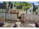 View of the backyard with a stone tiled patio, wooden fence, and mature trees at 6906 Park Ave, Atlanta, GA 30342