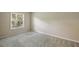 The bedroom has a large window that provides a natural light with a neutral colored carpet at 6906 Park Ave, Atlanta, GA 30342