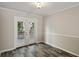 A well-lit dining area showcases stylish flooring and a door leading to an outdoor deck at 6906 Park Ave, Atlanta, GA 30342