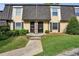 Charming exterior of townhomes with manicured lawn and inviting entryway at 6906 Park Ave, Atlanta, GA 30342