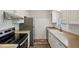 Bright kitchen featuring stainless steel appliances, light countertops, and white cabinets with wood style flooring at 6906 Park Ave, Atlanta, GA 30342