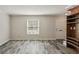 Bright living room showcasing hardwood style floors and built-in shelves with door to hallway at 6906 Park Ave, Atlanta, GA 30342