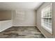 Living room with neutral paint, hardwood style flooring and natural light from large window at 6906 Park Ave, Atlanta, GA 30342