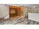 Open-concept living space featuring hardwood style floors, a built-in shelf, and staircase at 6906 Park Ave, Atlanta, GA 30342