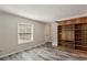 Living room with hardwood style flooring and built-in shelves with view of stairs and door at 6906 Park Ave, Atlanta, GA 30342