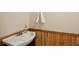 This powder room features a modern pedestal sink with wood paneled walls at 6906 Park Ave, Atlanta, GA 30342