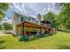 Backyard featuring a covered deck, lush lawn, mature trees, and ample space for outdoor entertaining at 75 Puppy Chase, Social Circle, GA 30025