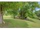 Expansive backyard with mature trees, lush green lawn, and a serene setting, perfect for outdoor enjoyment at 75 Puppy Chase, Social Circle, GA 30025