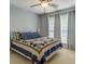 Cozy bedroom featuring a ceiling fan, natural light, and tasteful decor at 75 Puppy Chase, Social Circle, GA 30025