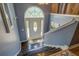 Spacious entryway with wooden stairs, blue walls and decorative front door at 75 Puppy Chase, Social Circle, GA 30025