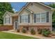 Charming home featuring blue shutters, brick accents, fresh flowers and a lovely arched front door at 75 Puppy Chase, Social Circle, GA 30025