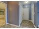 Hallway with tile flooring, neutral paint, and multiple doors, offering access to various rooms at 75 Puppy Chase, Social Circle, GA 30025