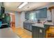 Charming kitchen featuring blue cabinetry, wooden floors and stainless steel appliances at 75 Puppy Chase, Social Circle, GA 30025