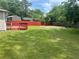 Expansive backyard with a vibrant green lawn, wooden deck and tall trees at 8922 Gatewood Cir, Jonesboro, GA 30238