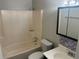 Functional bathroom with a combined tub and shower, updated vanity, and essential fixtures at 8922 Gatewood Cir, Jonesboro, GA 30238
