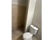 Tiled bathroom featuring a walk-in shower and a water-efficient toilet at 8922 Gatewood Cir, Jonesboro, GA 30238