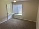 Comfortable bedroom featuring neutral carpeting, a large window, and ample natural light at 8922 Gatewood Cir, Jonesboro, GA 30238