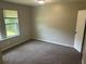 Serene bedroom offering neutral carpeting, a bright window, and a peaceful retreat at 8922 Gatewood Cir, Jonesboro, GA 30238