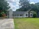 Charming single-story home with a well-maintained lawn and classic architectural details at 8922 Gatewood Cir, Jonesboro, GA 30238