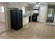 Efficient kitchen with essential appliances, neutral cabinetry, and durable tiled flooring at 8922 Gatewood Cir, Jonesboro, GA 30238