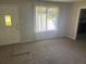 Inviting living room with plush carpeting, a bright window, and a welcoming atmosphere at 8922 Gatewood Cir, Jonesboro, GA 30238