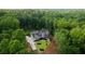 Areal view of home nestled among green trees, with driveway and well maintained lawn at 1084 Wrights Mill Rd, Canton, GA 30115