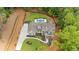 Expansive aerial view of the property featuring a custom home, in-ground pool, and lush landscaping at 1084 Wrights Mill Rd, Canton, GA 30115