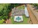 Aerial view showcasing the home's expansive lot, long driveway and stunning pool, perfect for privacy at 1084 Wrights Mill Rd, Canton, GA 30115