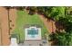 Aerial perspective of backyard featuring a swimming pool, landscaping, and verdant lawn at 1084 Wrights Mill Rd, Canton, GA 30115